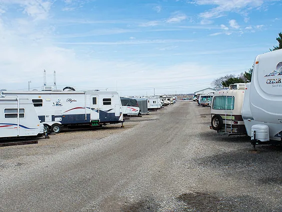 RV parked in secure outdoor storage facility at J&J